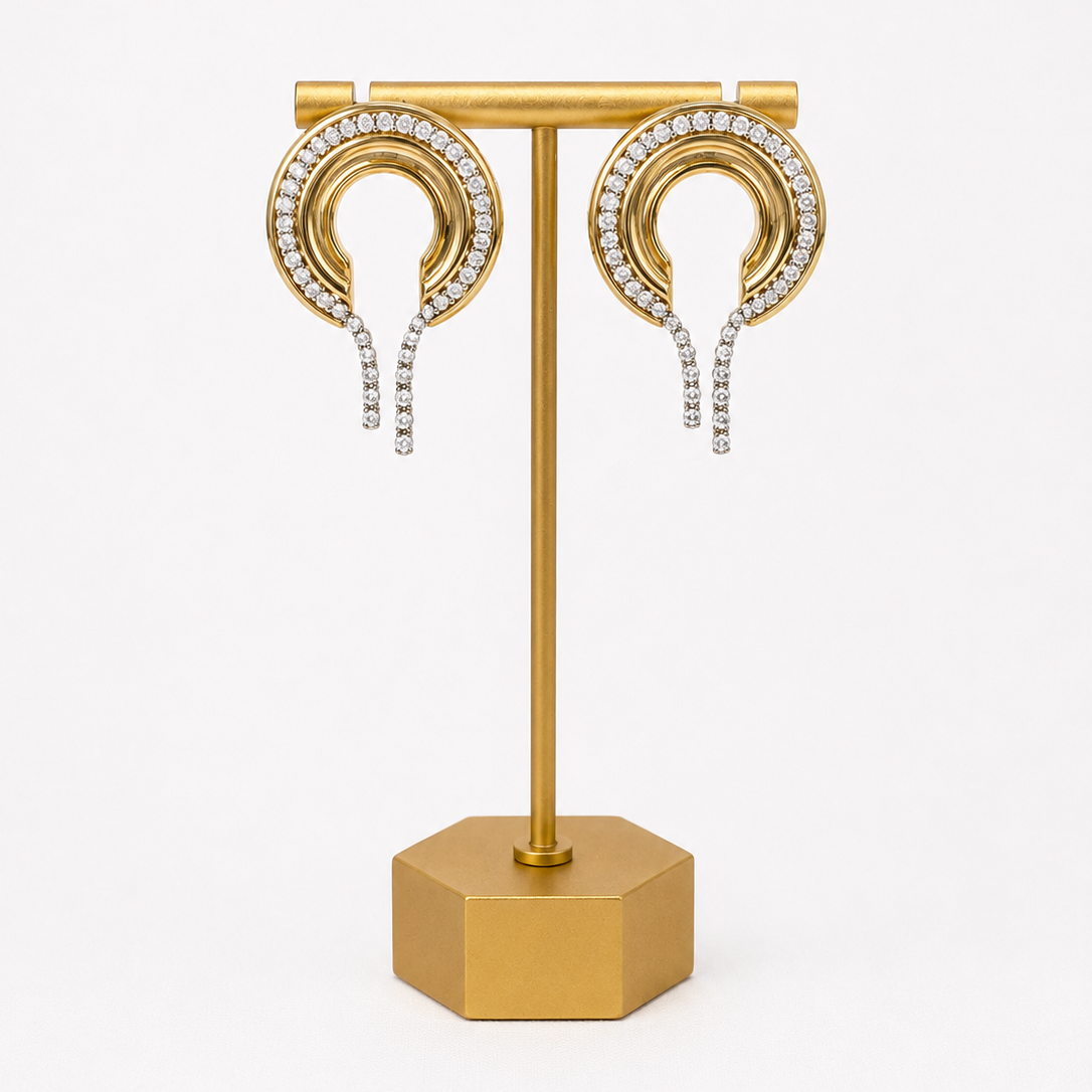 Gold plated CZ Lady Lou Collections earrings on a gold display stand with a white background