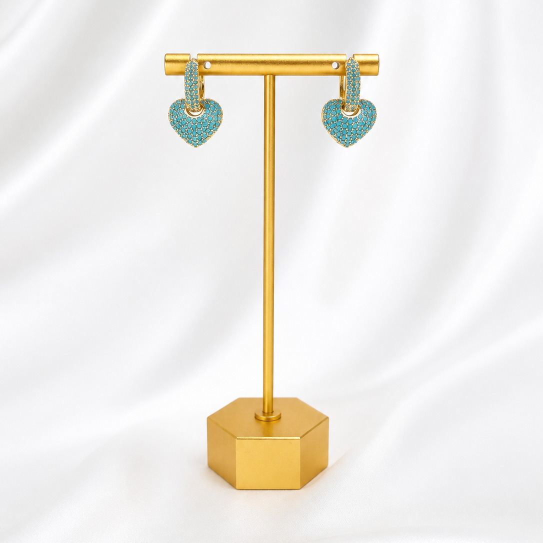 Lady Lou Collectipns Turquoise heart-shaped gold plated earrings on a gold stand against a white background