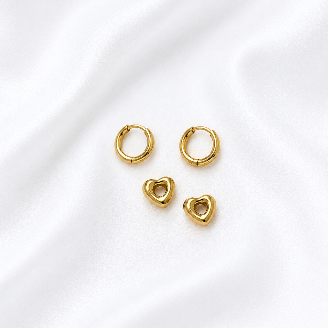 Set of Lady Lou Collections gold plated hoop and heart-shaped earrings on a white background