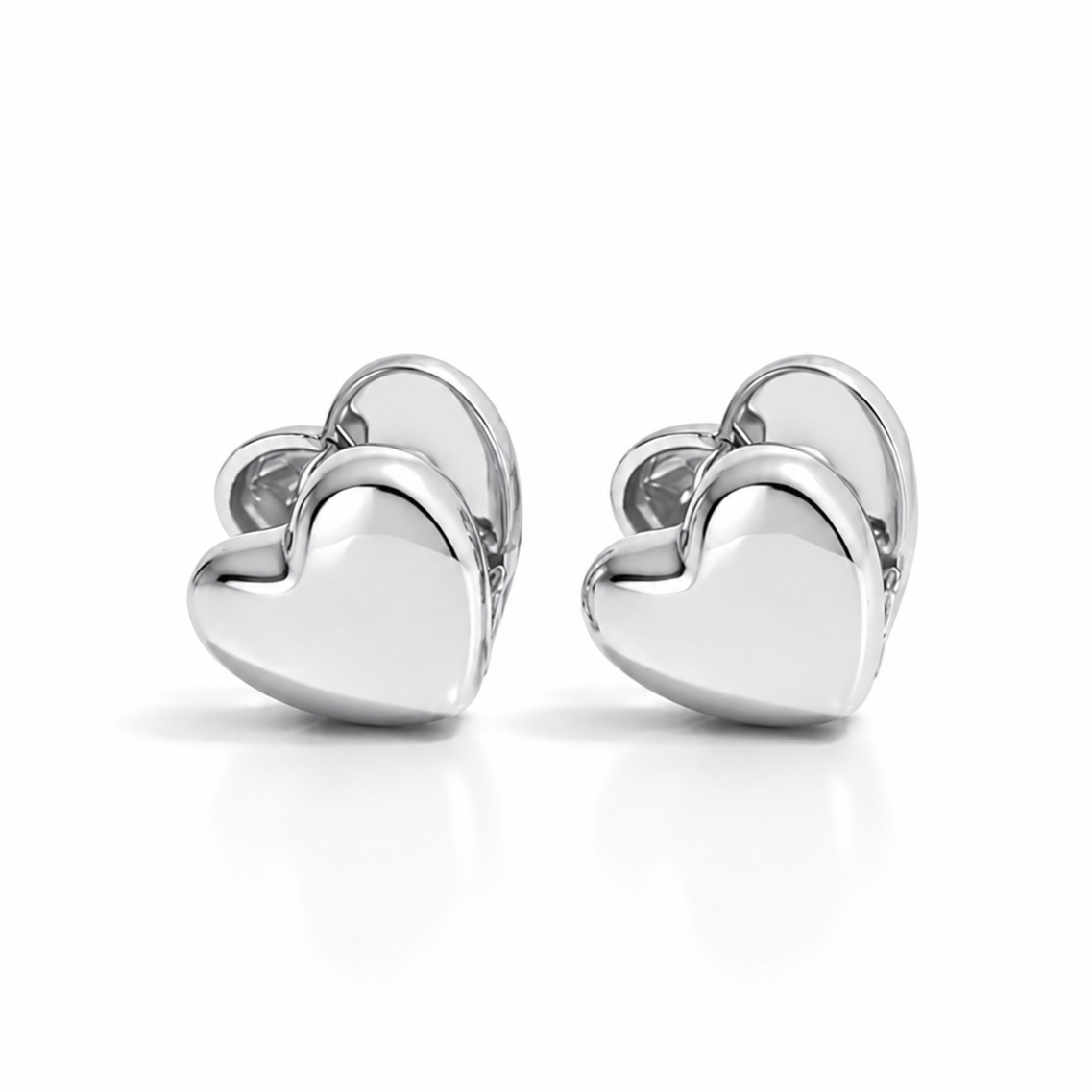 Pair of silver heart-shaped earrings on a white background