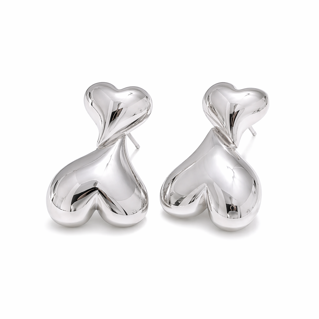 Silver heart-shaped earrings on a white background Maggie Earrings