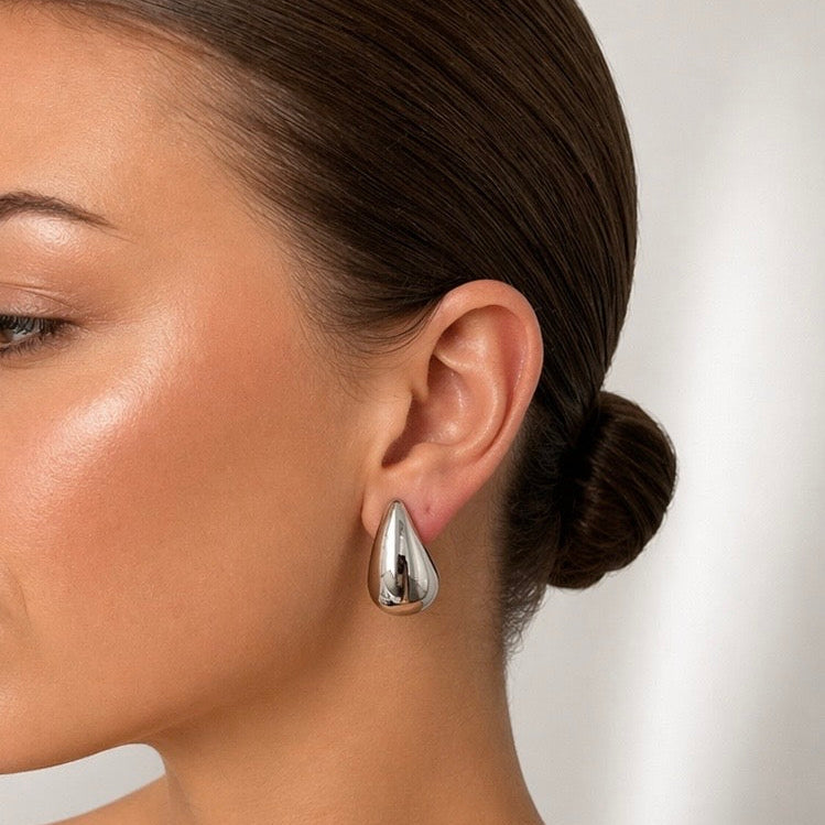 Woman wearing Mia silver earrings with slick back bun minimal everyday styling