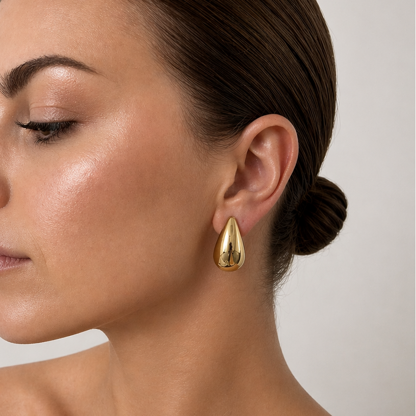 Woman wearing Millie gold statement stud earrings styled with minimal jewellery