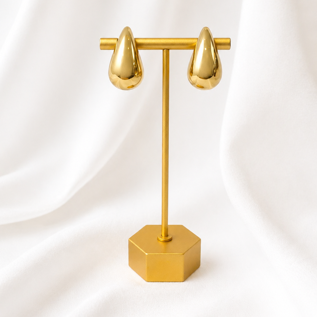 Millie gold stud earrings displayed on stand minimal jewellery styling