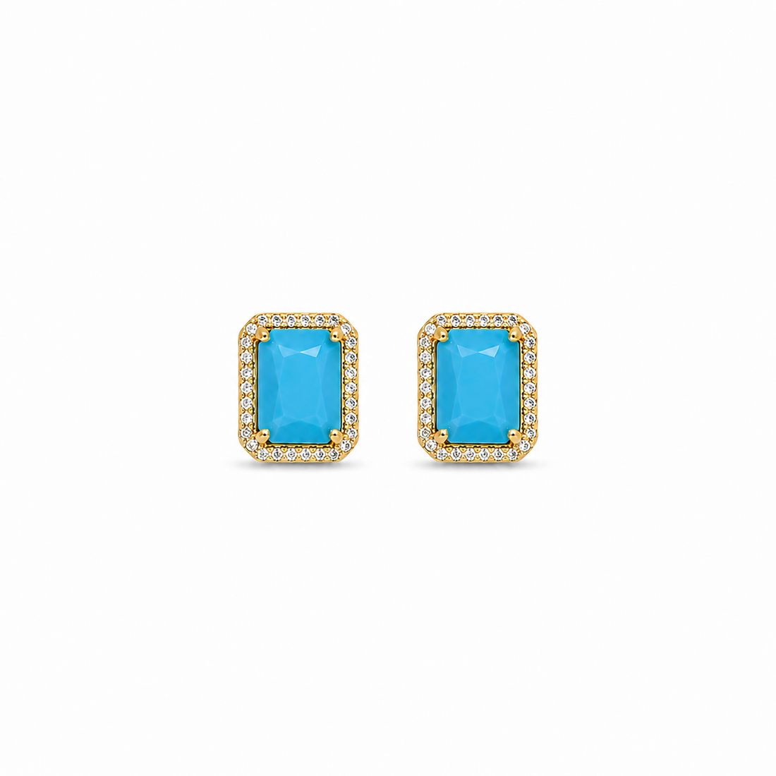 Pair of earrings with blue gemstones and gold frames on a white background