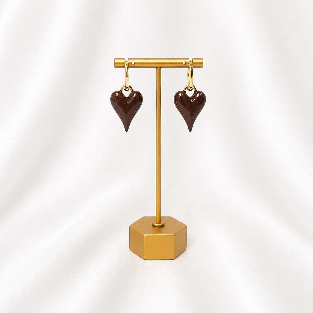 Mocha Brown Heart-shaped earrings on a gold stand against a white background
