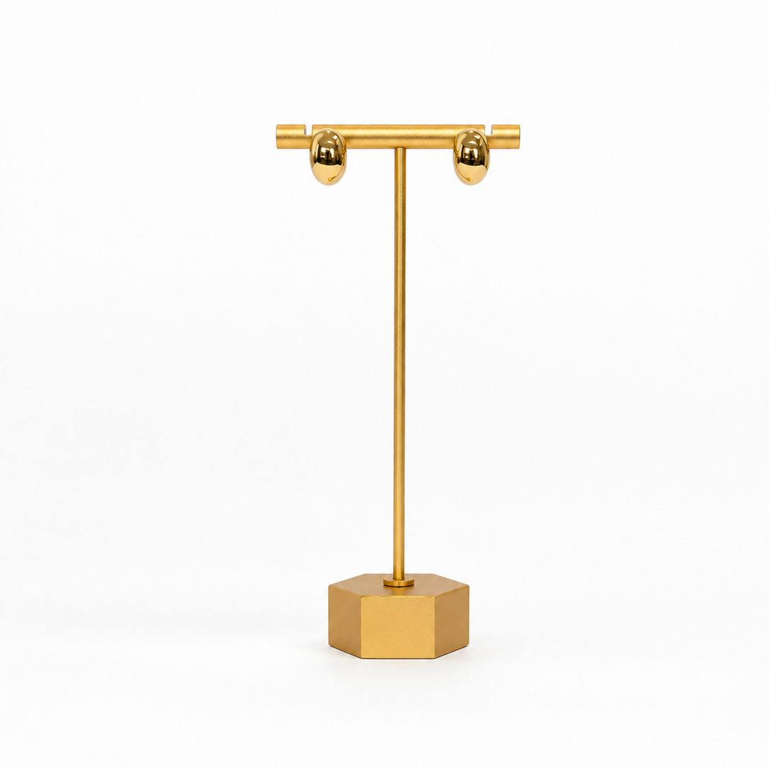 Gold jewelry stand on a white background