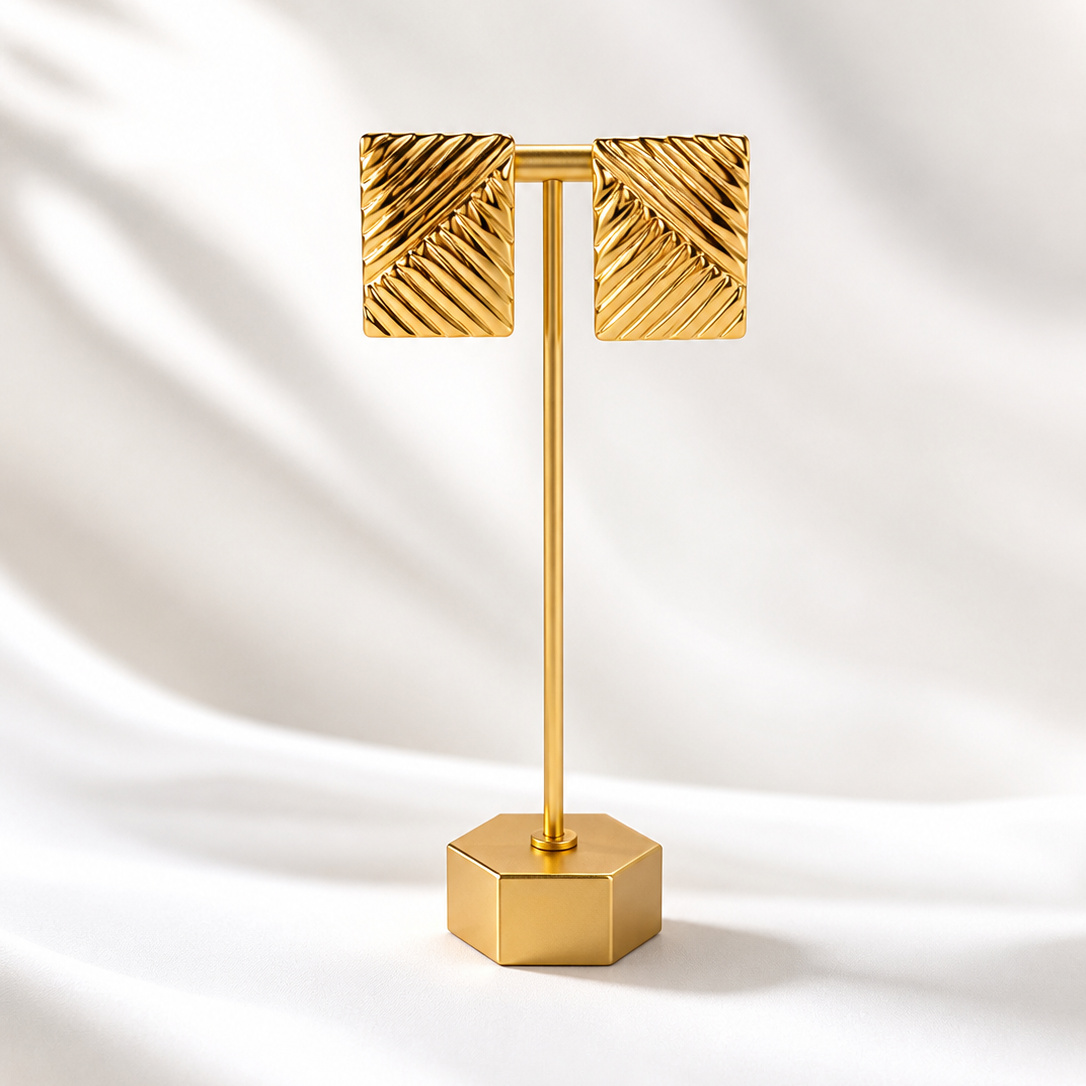 Gold plated rectangle  earrings on gold stand and white background