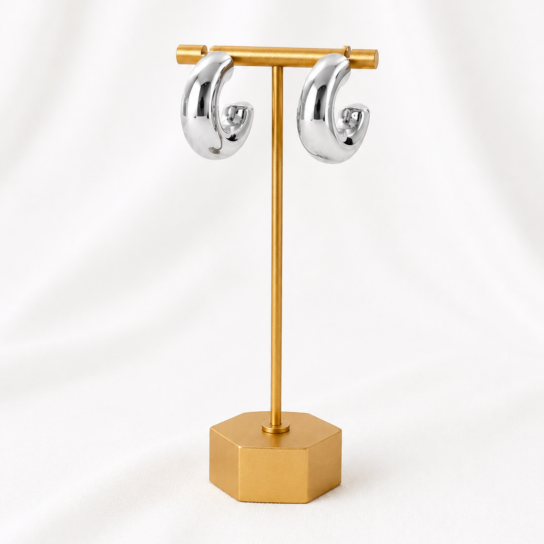 Gold Lady Lou Collections earring stand with silver earrings on a white background