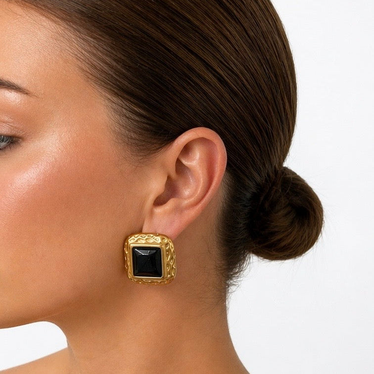 Woman wearing a zarie gold and black stud earrings